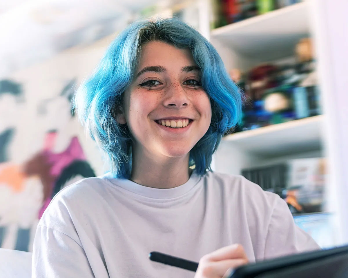Girl using a pen and smiling