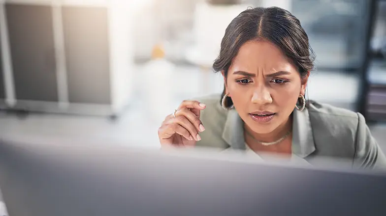 person looking at a computer confused